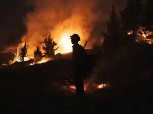 Firefighters Persist in Containing Wildfires in California as Winds Diminish