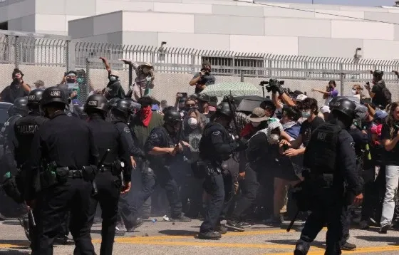 Why was a curfew implemented in downtown LA after protests and looting?